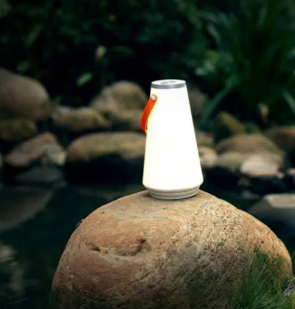 White rechargeable LED lantern night light with USB cable on a table