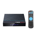 Black T95 Max Plus Android TV box with remote control on a table.