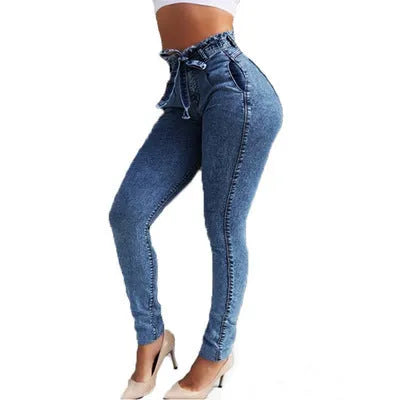 Pair of light blue jeans with a fringed raw hem on a mannequin.