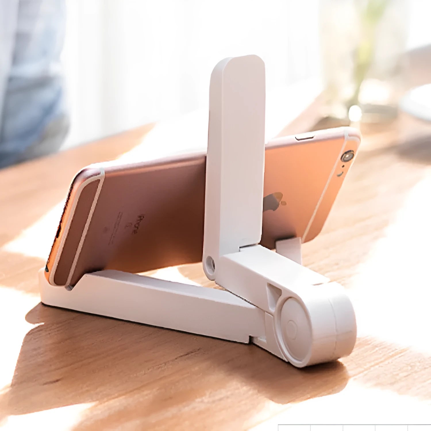 Black foldable tablet holder supporting tablet in landscape position on desk