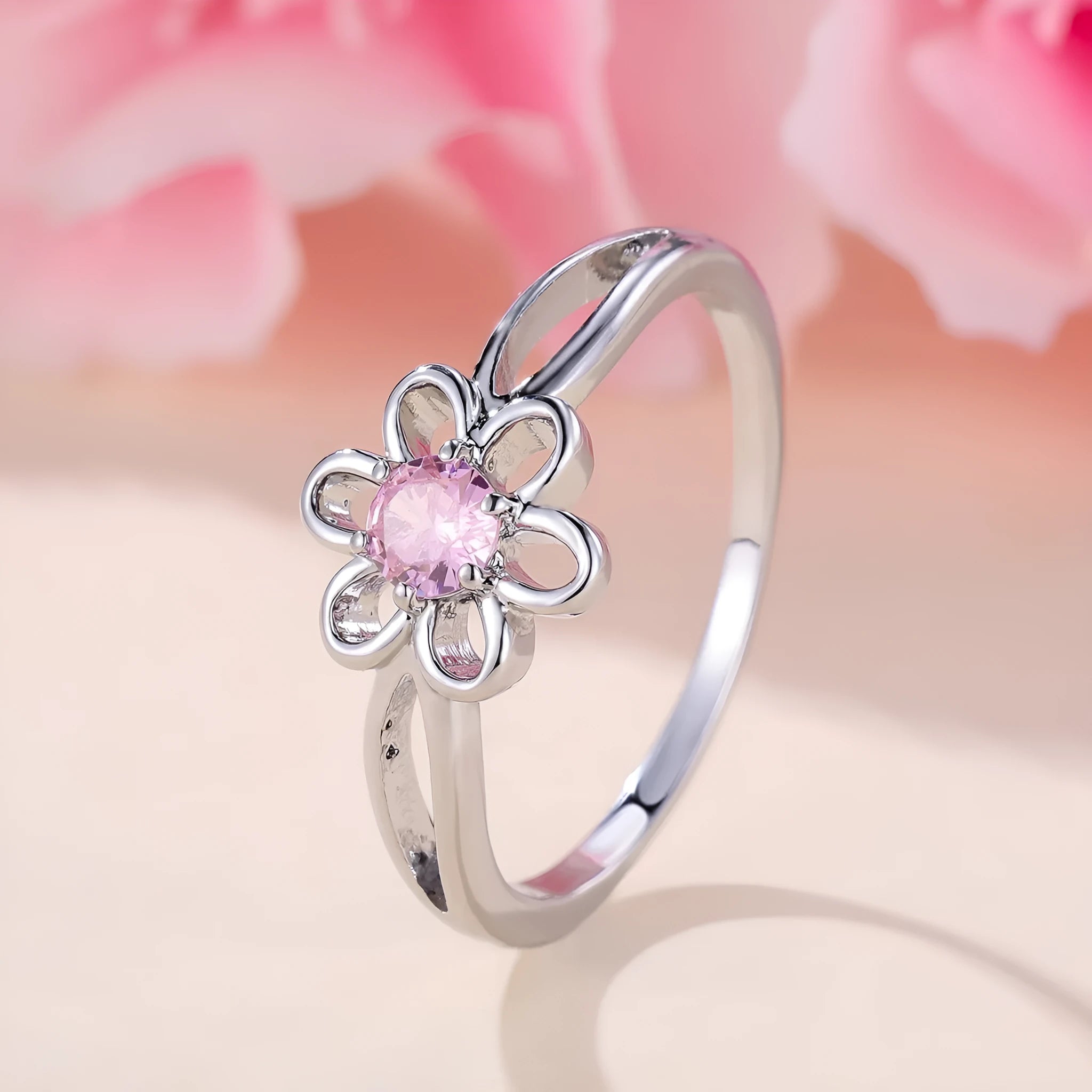 Lady's copper ring with hollowed flower design in platinum pink diamond colour showing size options
