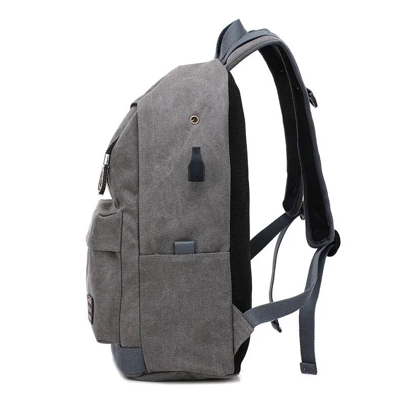 Canvas backpack with USB charging port shown in coffee colour, featuring a laptop compartment and multiple pockets.