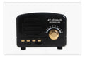 Vintage wood finish bluetooth speaker in pink, black, and wood grain colour options showing compact design