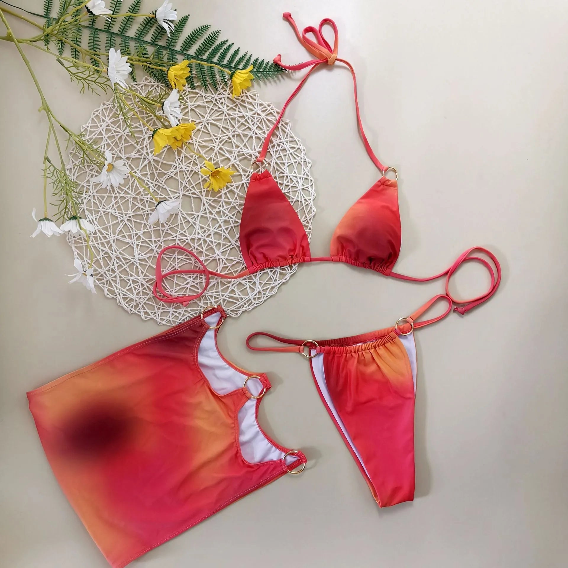 Women's tie-dye gradient halter bikini three-piece swimwear set showing top, pants and skirt
