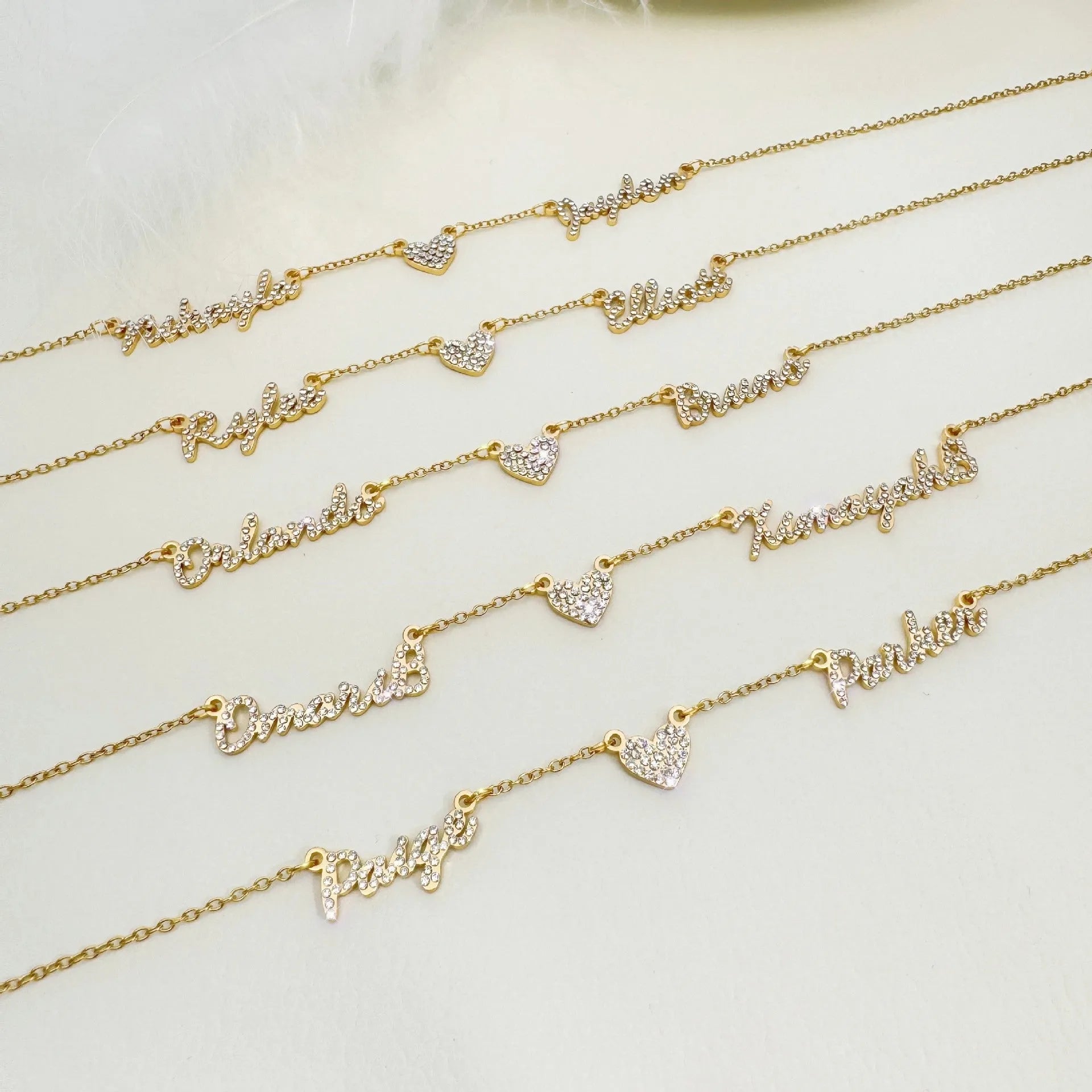 Customised diamond inlaid multi name necklace on stainless steel O-shaped chain, gold finish, with heart charms