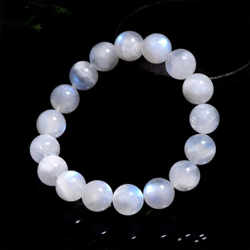 Natural blue moonlight round moonstone bead bracelet on a white background showing polished spherical beads.