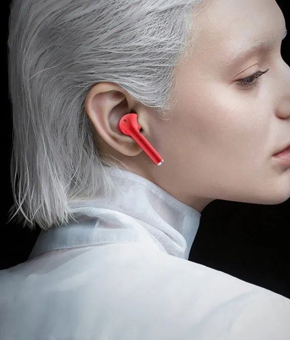 Lipstick-style wireless Bluetooth earphones in charging case, available in black, pink, purple, and white colours.