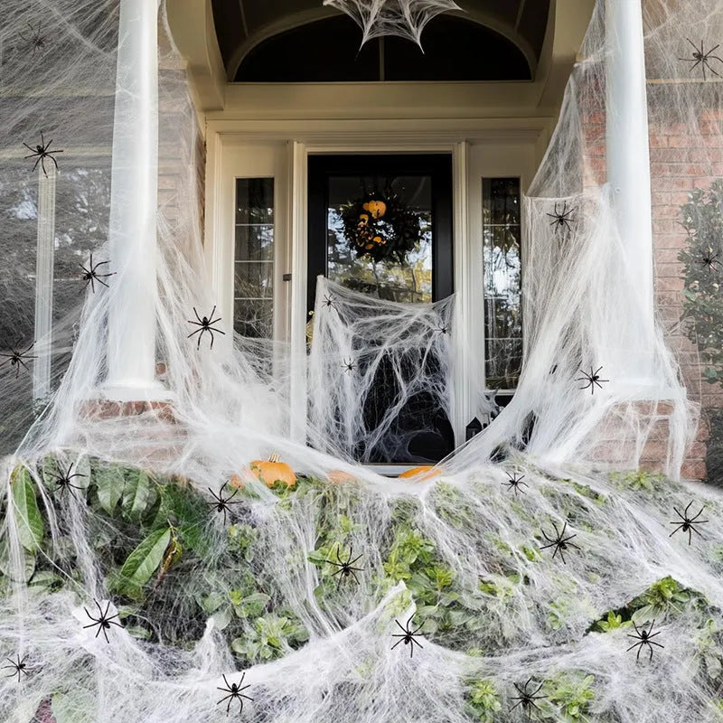 White cotton spider web Halloween decoration props draped across corner with multiple spiders