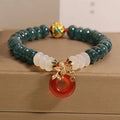 Women's crystal bracelet with blue water jade and red agate beads featuring safety buckle closure