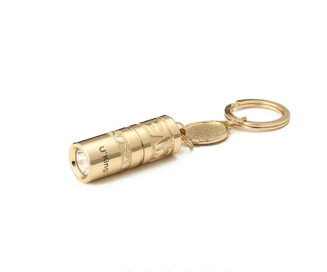 Gold zinc alloy waterproof mini LED flashlight on a keychain.