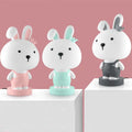 Cartoon-style animal LED table lamp on a table, showing one random design from Bear, Cattle, Rabbit, or Tiger options.