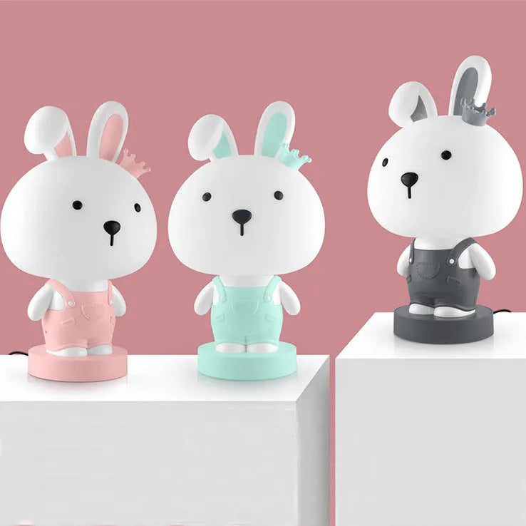 Cartoon-style animal LED table lamp on a table, showing one random design from Bear, Cattle, Rabbit, or Tiger options.
