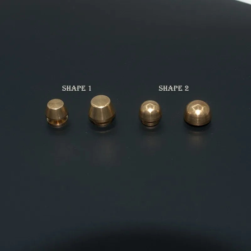Brass decorative foot nail buckle in round and geometric designs, sizes 10x6mm and 12x7mm.