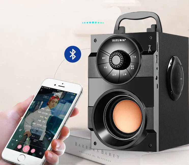 Black portable mini audio system with subwoofer, connection cable, and charging accessories