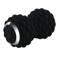 Electric peanut fascia massage ball in black and sky blue on a gym floor for muscle recovery