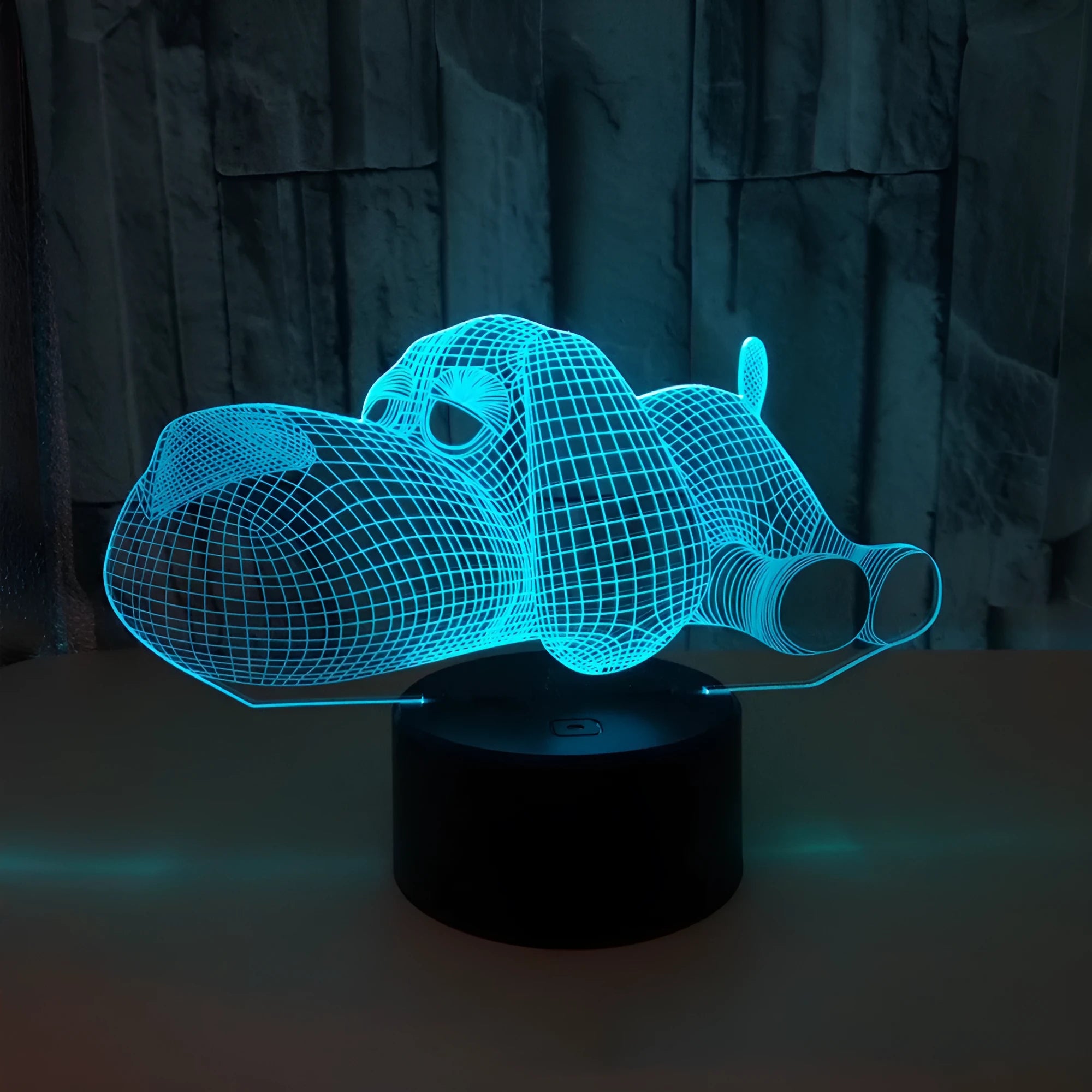 Doggo Desktop Lamp showing 3D dog illusion glowing in blue light on a desk