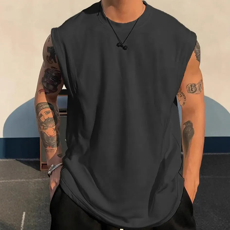 Men's loose fit cotton sleeveless t-shirt in a solid colour, shown on a hanger.