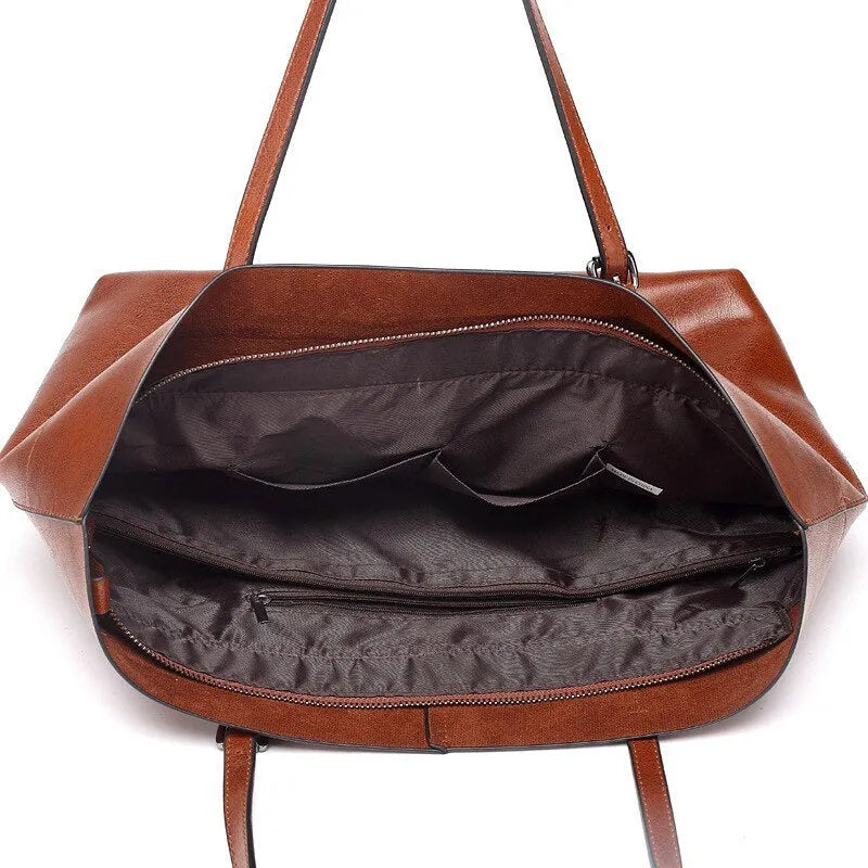 Horizontal waxed cowhide leather cross-body handbag showing two main compartments and phone pocket organisation