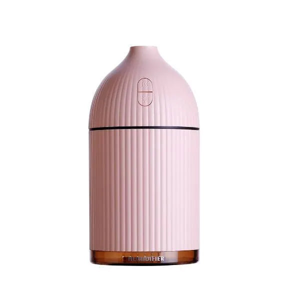 White square aromatherapy diffuser and humidifier with LED light on a wooden desk.