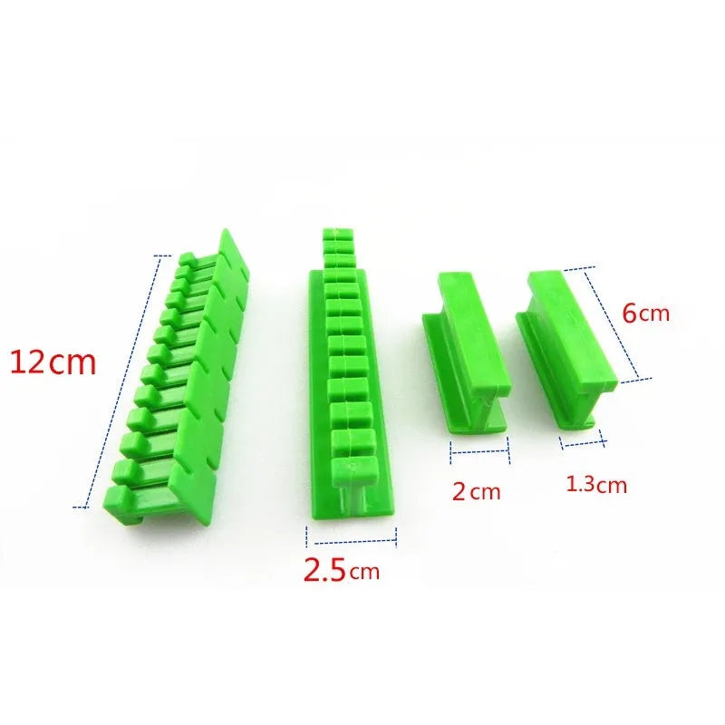 Car dent repair tool set with green adhesive labels and aluminium alloy supports on a workbench