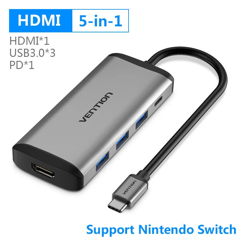 Deep grey Type-C multi-port adapter hub with HDMI, USB, Ethernet, and card reader ports.