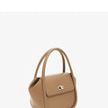 A wing-shaped cow leather tote bag with a buckle latch closure, shown in blue with a single cross-body strap.