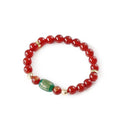 New Chinese style red agate Guanyin bracelet with auspicious patterns on a wrist.