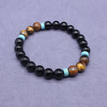 Black agate bracelet and matching tiger's eye geometric necklace set on a plain background.