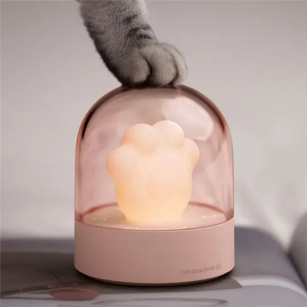 Grey or pink cat paw shaped night light with USB charging port and music box functionality