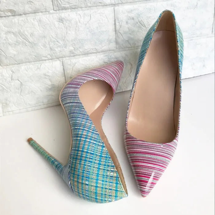 Pink to blue gradient patent leather ladies pointed toe high heels on a plain background