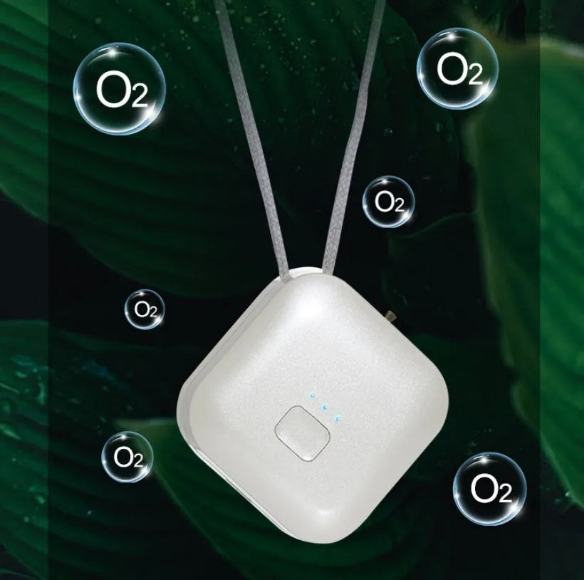 Mini USB air purifier pendant on a necklace, shown in pink colour with charging cable.