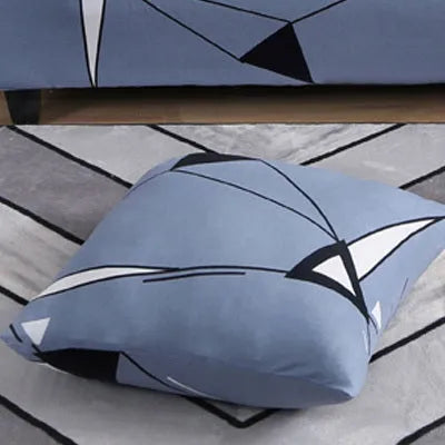Geometric print stretch sofa slipcover fitted on a grey three-seater sofa.
