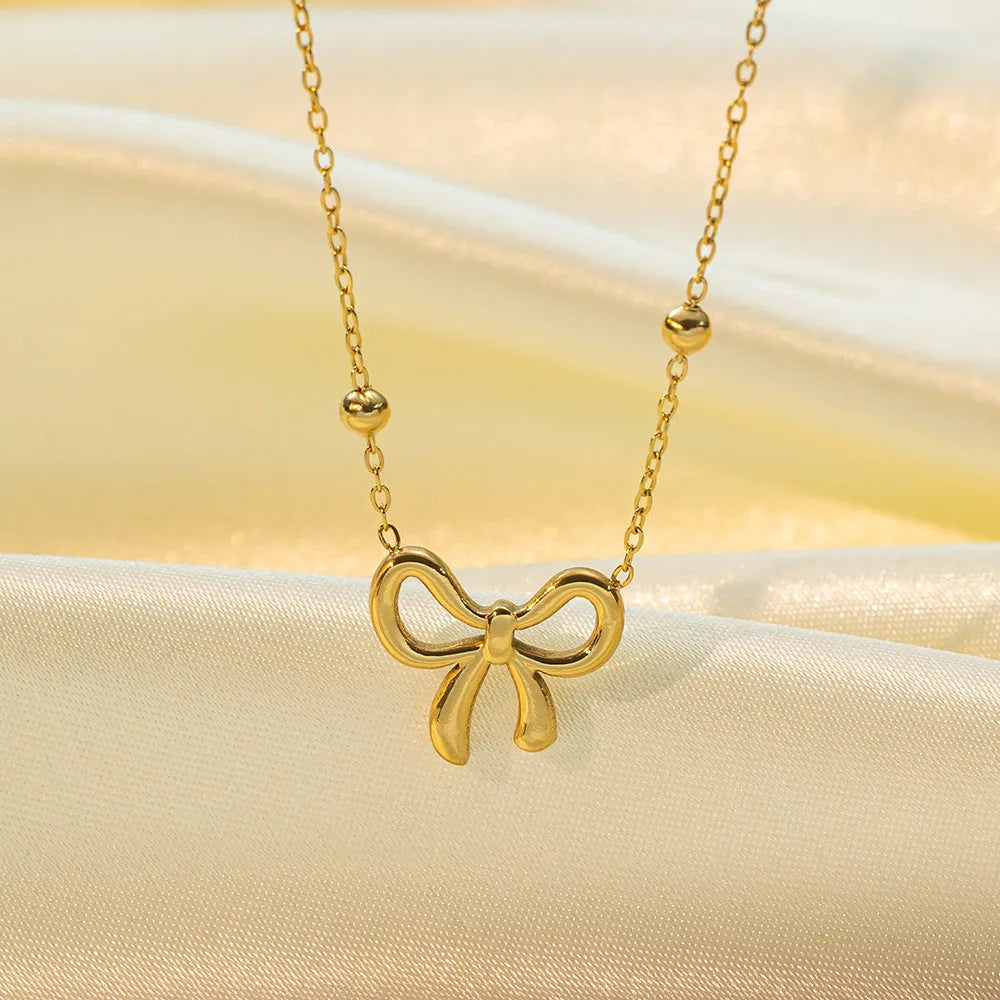 Gold bow necklace on titanium steel cross chain with adjustable 41-50cm length