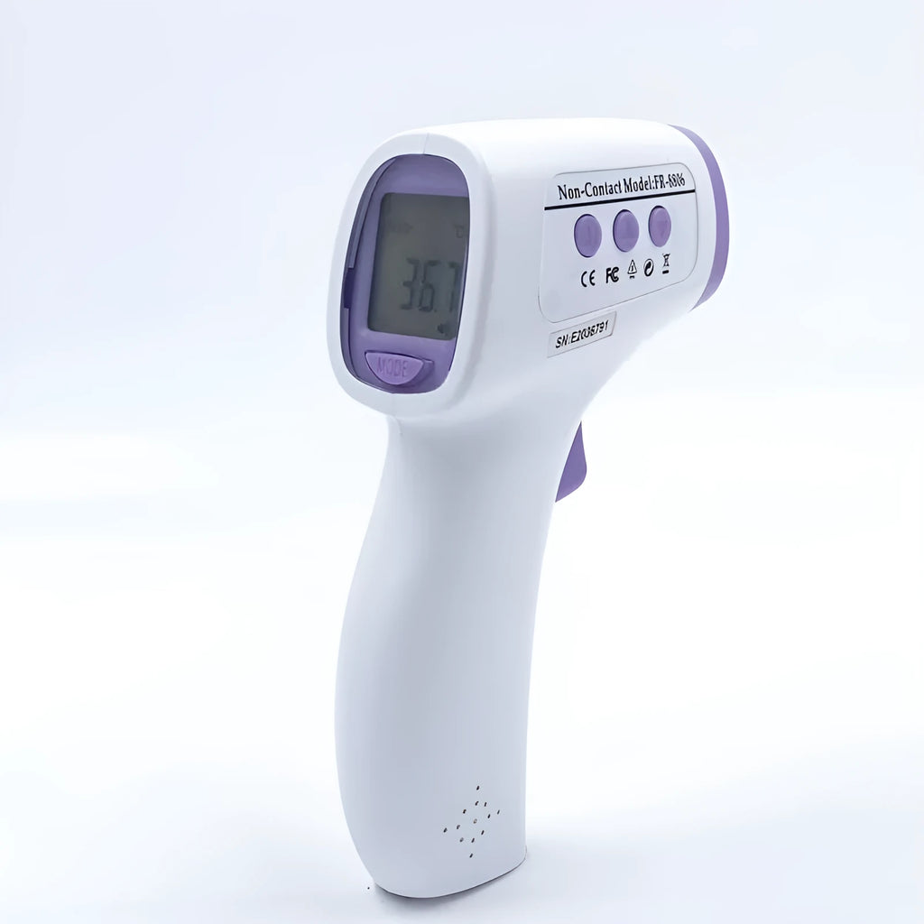White digital thermometer for non-contact temperature measurement on a table.