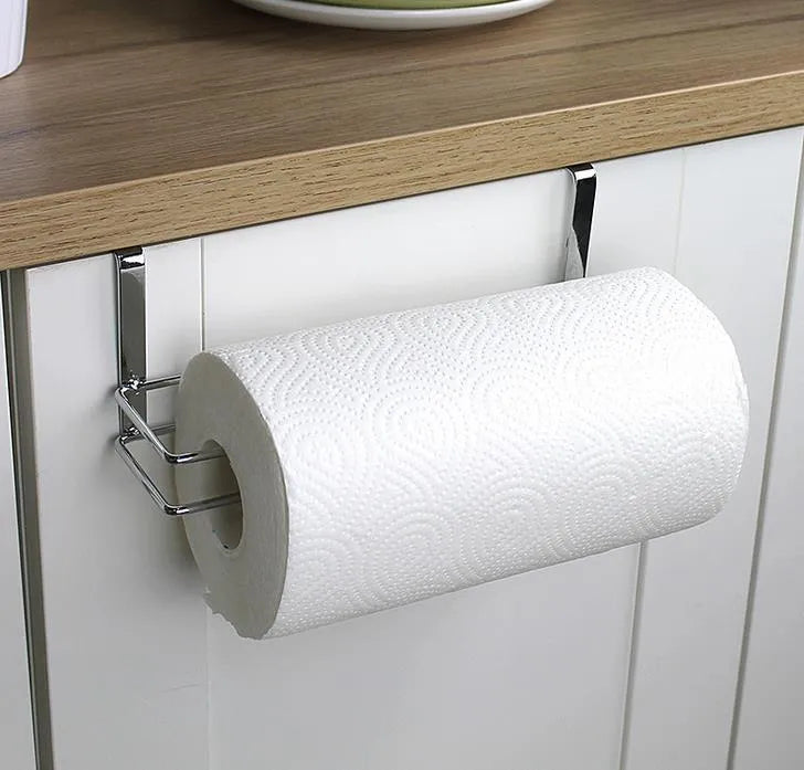 Silver stainless steel paper towel rack hanging on kitchen cabinet door