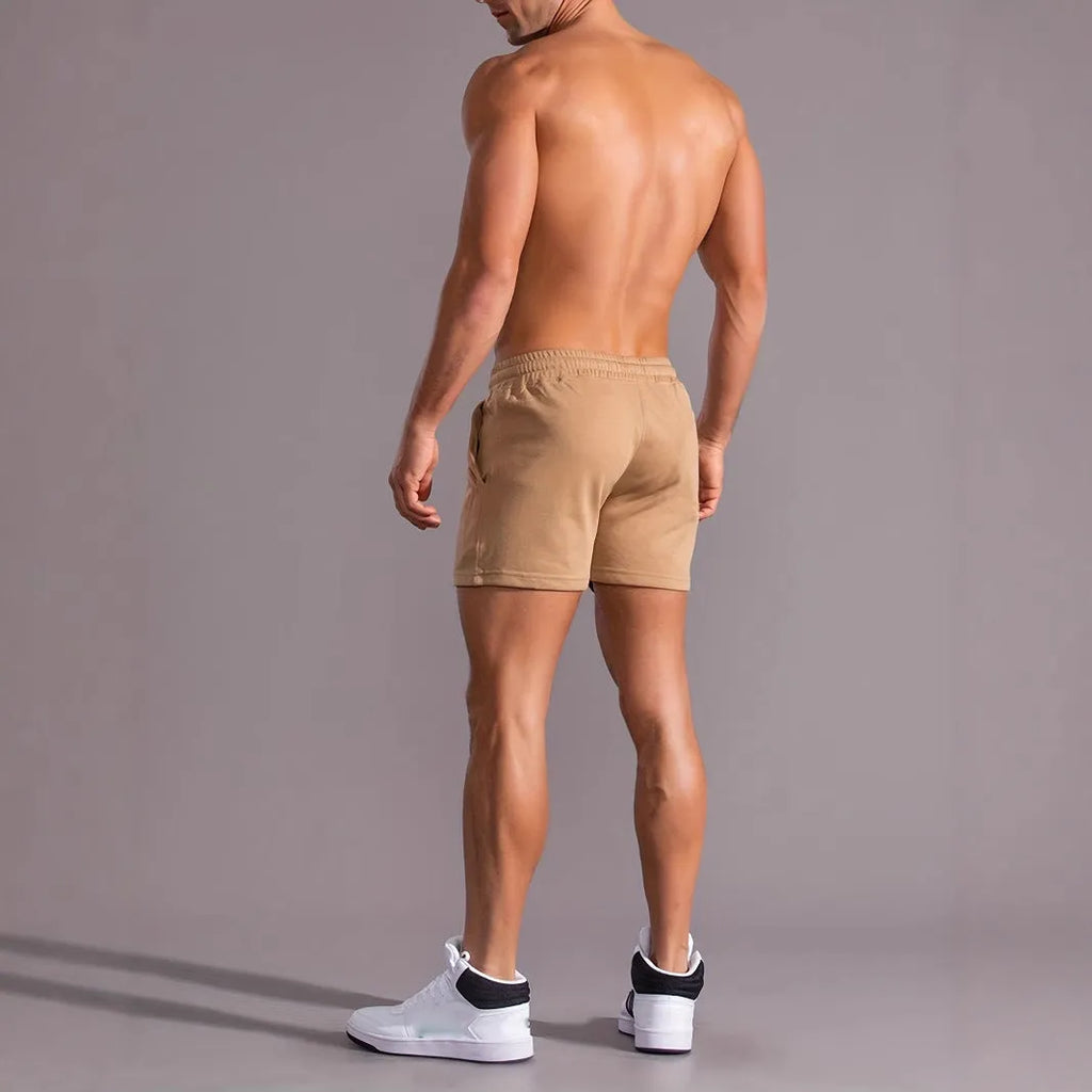 Men's khaki sports shorts with a coconut leaf print, showing straight-leg cut.