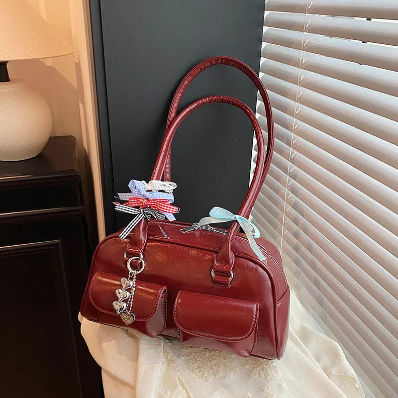 Retro-style black PU leather women's pillow bag with double shoulder straps and a flap closure.