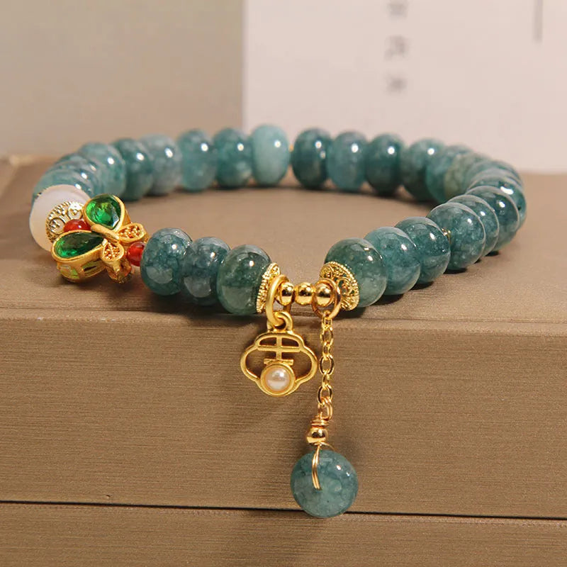 Blue water jade bracelet with white agate abacus beads and butterfly charm