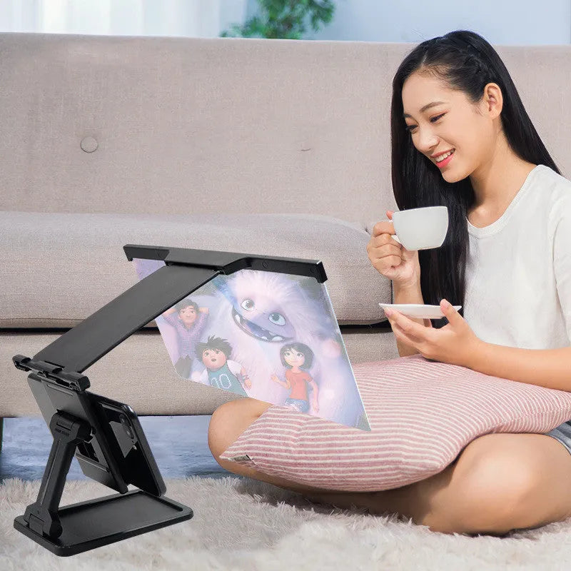 Black L20 split mobile phone screen magnifier with 12-inch acrylic lens and ABS plastic shell on a desktop.