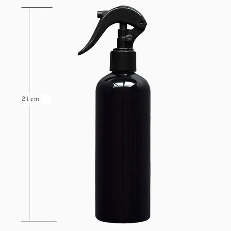 Black plastic and metal succulent plant tool set with 16 pieces including tweezers, shovel, and watering bottle on a grey cushion.