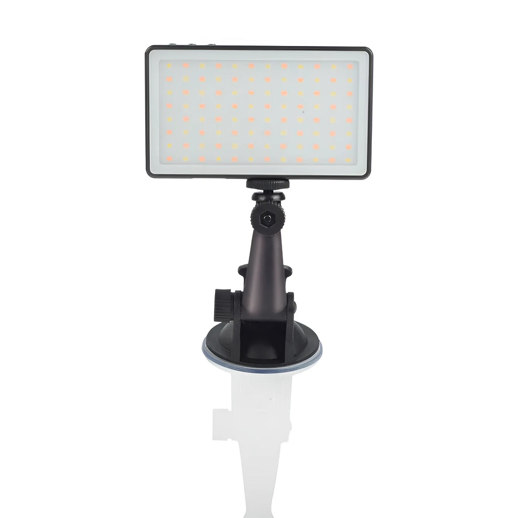 Black aluminium LED video light panel with clip mount, shown illuminating a person on a laptop video call.