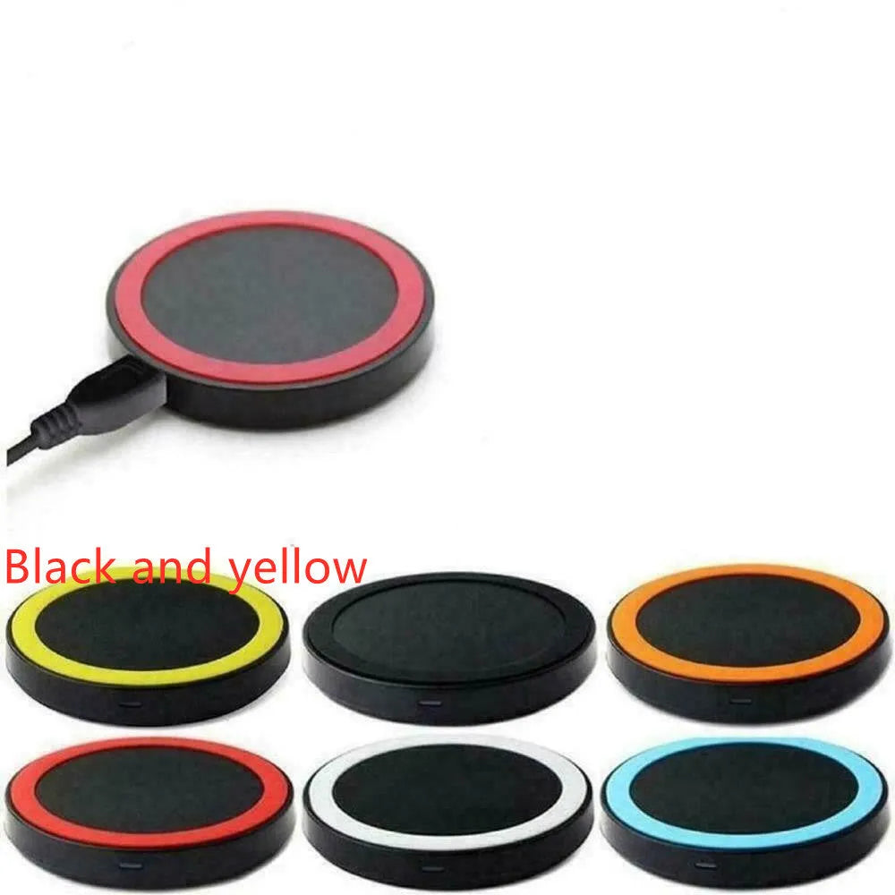 Square wireless charging base for mobile phones in six colour options on a wooden desk.