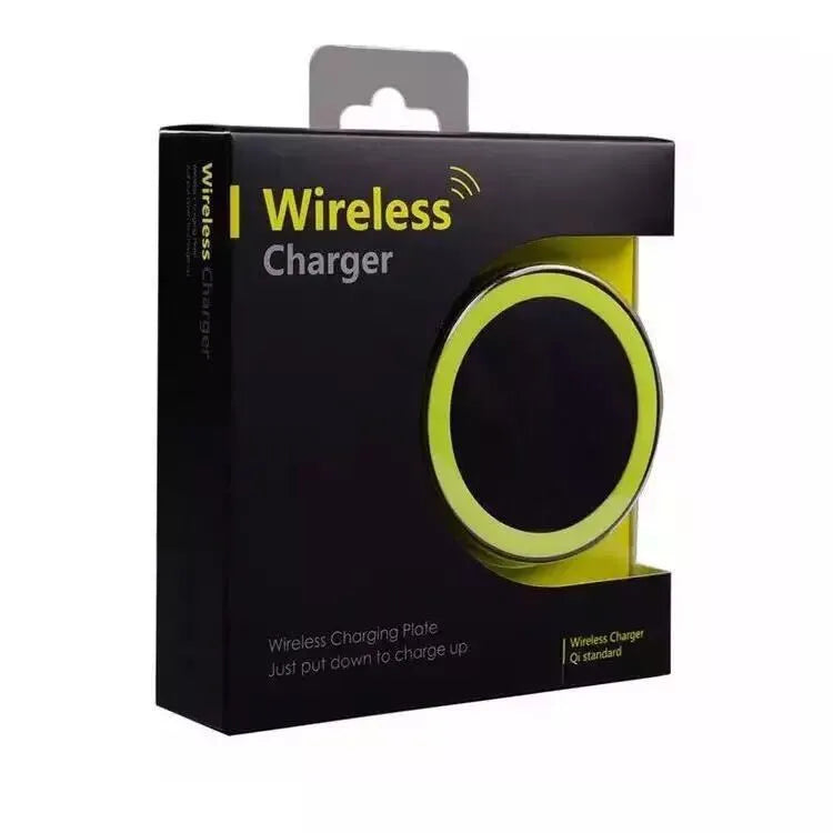Square wireless charging base for mobile phones in six colour options on a wooden desk.