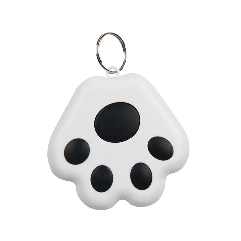 Small black dog paw shaped Bluetooth tracker device on a keyring against a white background.