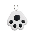 Small black dog paw shaped Bluetooth tracker device on a keyring against a white background.