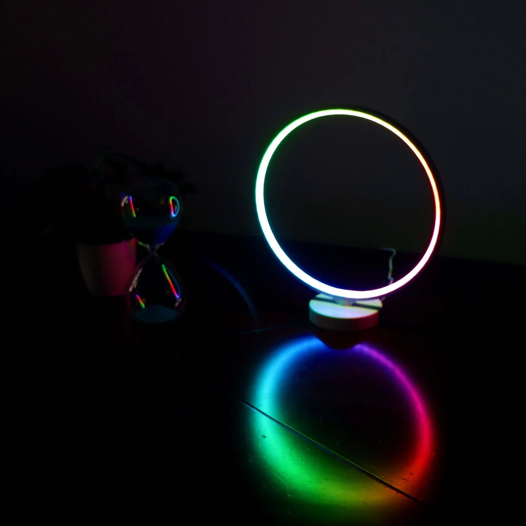 3D Full Moon Lamp on a table showing detailed lunar surface texture, with remote control for colour adjustment.