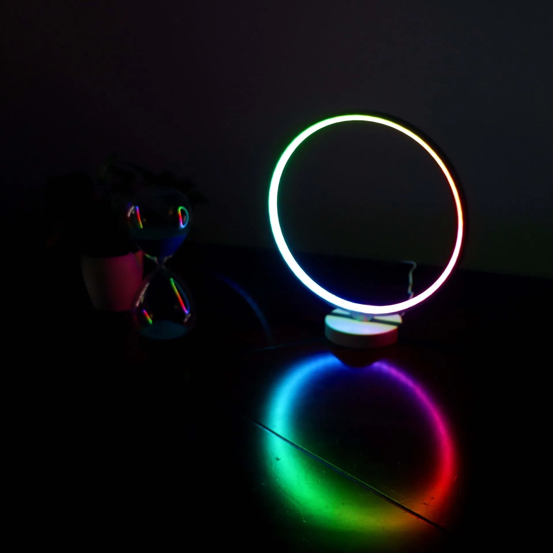 3D Full Moon Lamp on a table showing detailed lunar surface texture, with remote control for colour adjustment.