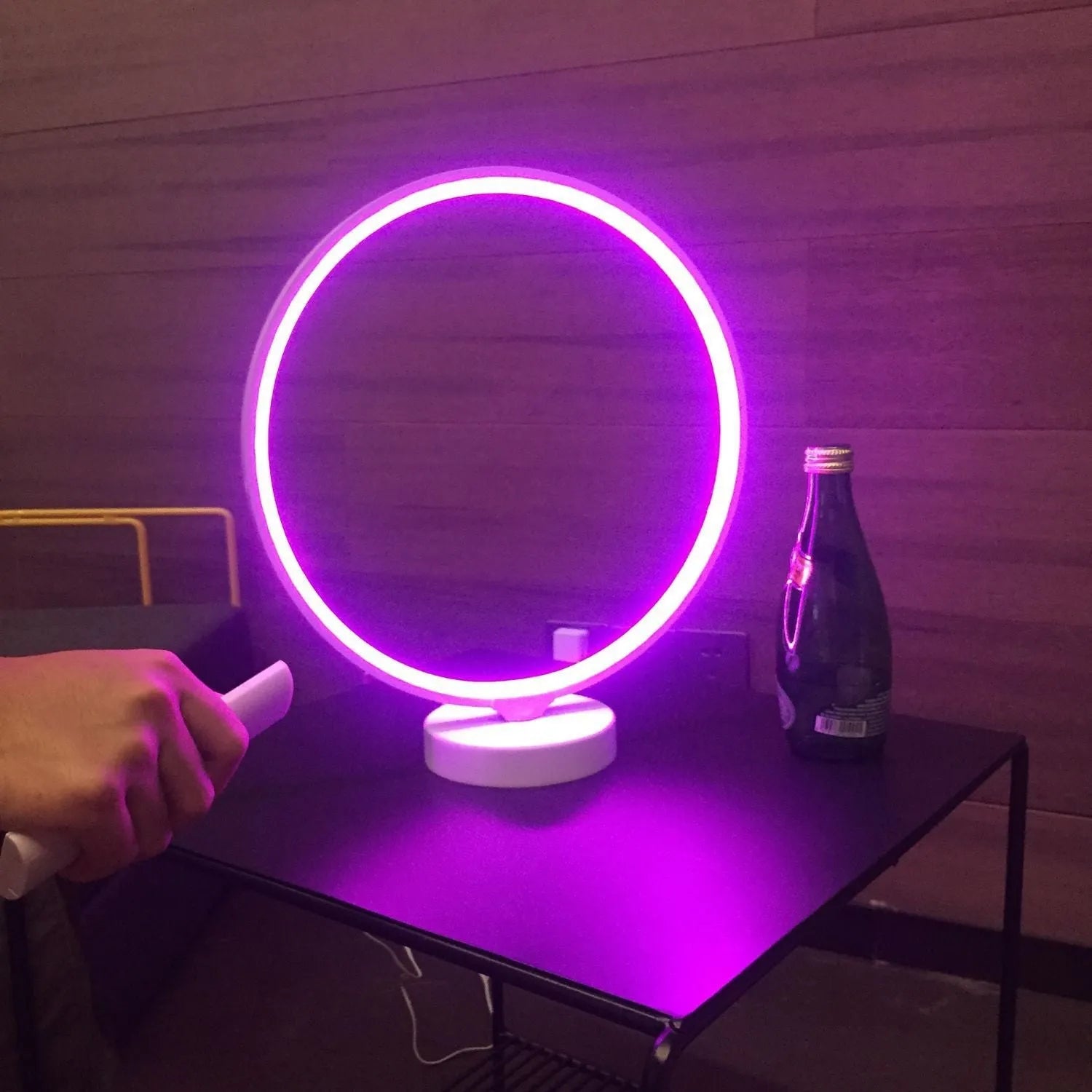 3D Full Moon Lamp on a table showing detailed lunar surface texture, with remote control for colour adjustment.