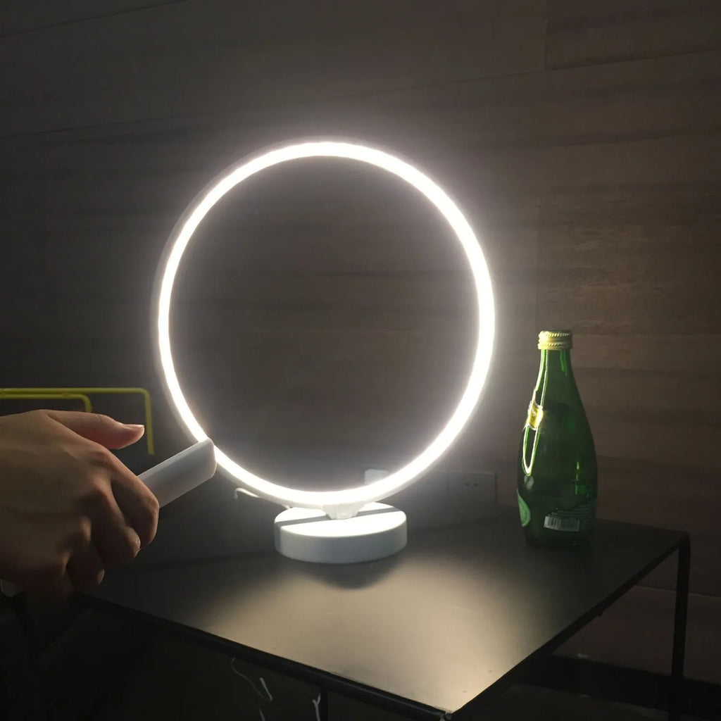 3D Full Moon Lamp on a table showing detailed lunar surface texture, with remote control for colour adjustment.