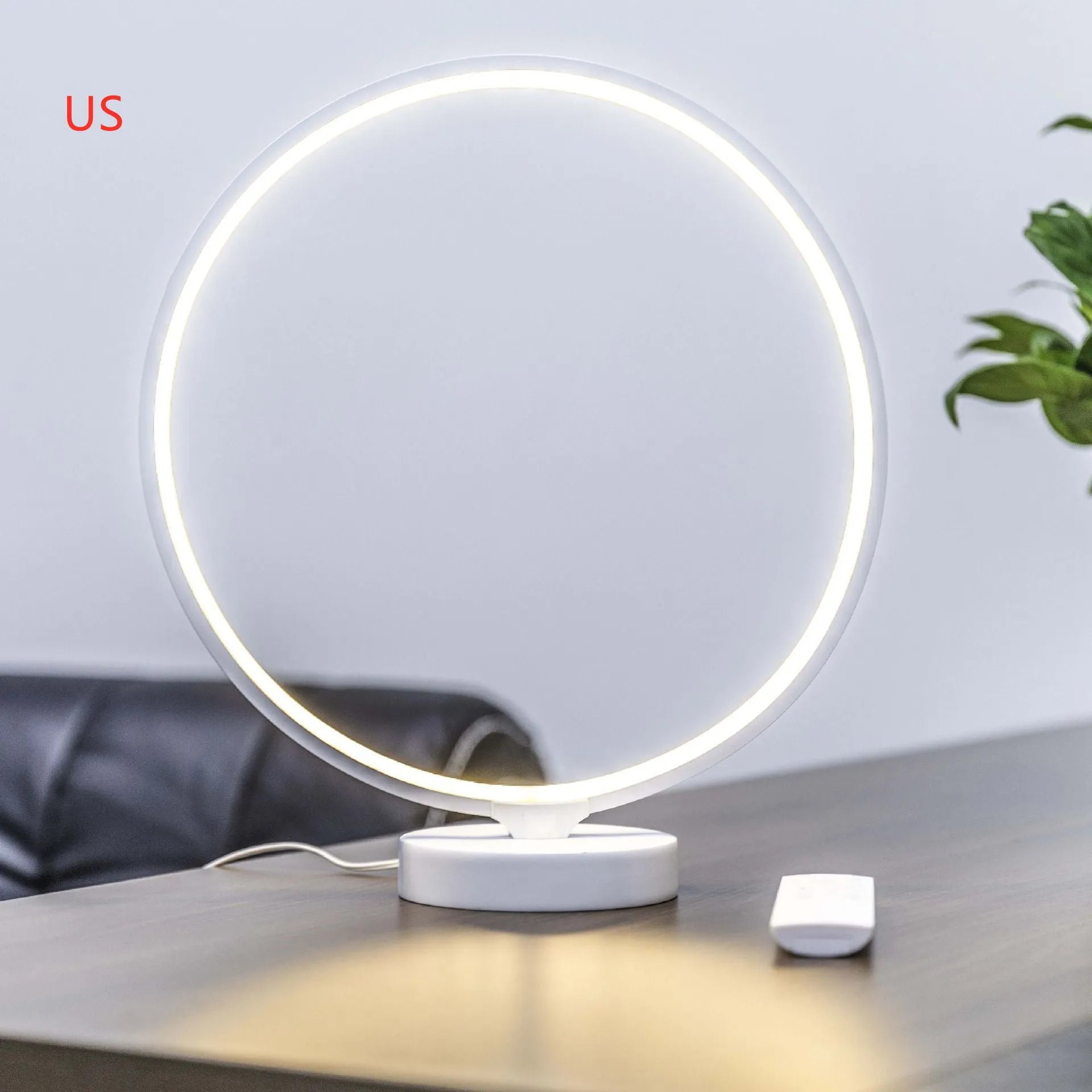 3D Full Moon Lamp on a table showing detailed lunar surface texture, with remote control for colour adjustment.
